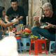 Anthony Bourdain eating at a sidewalk cafe